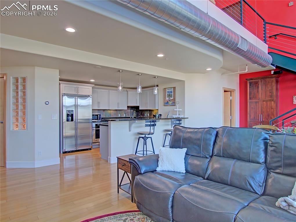 Image 8 of 20: Living room featuring light wood-type flooring and recessed lighting