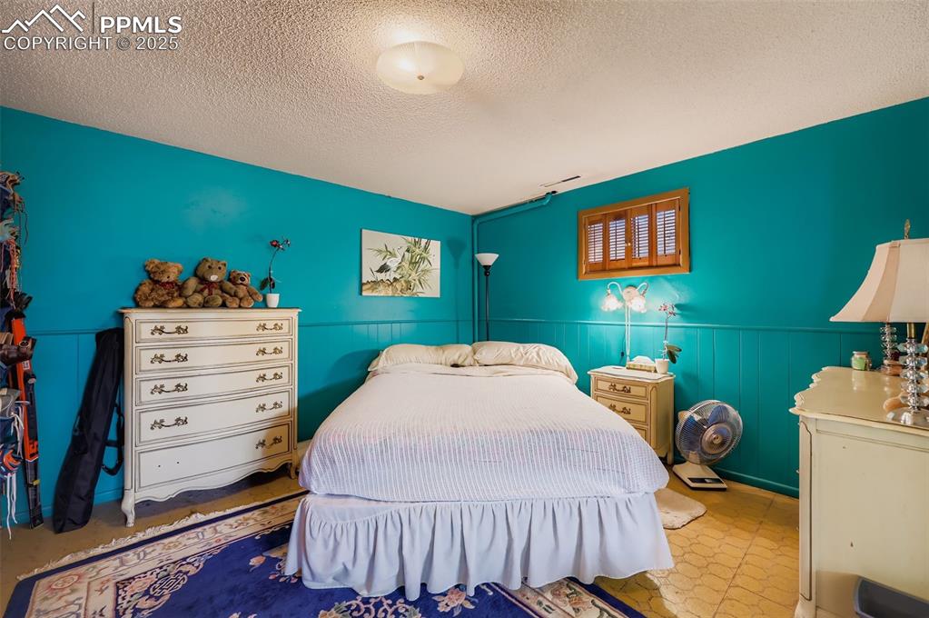 Image 18 of 23: Bedroom featuring a textured ceiling