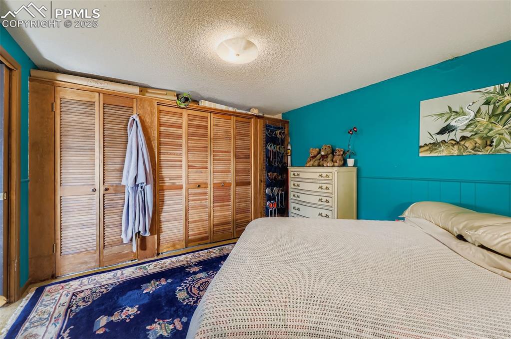 Image 19 of 23: Bedroom with a closet and a textured ceiling