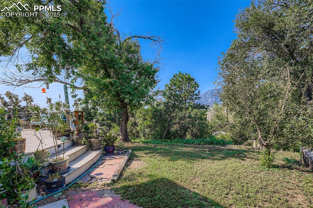 Image 23 of 23: View of green lawn featuring a patio area