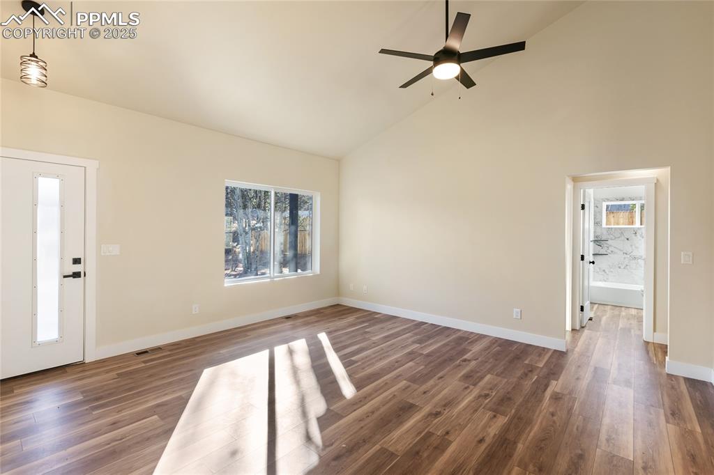 Image 10 of 38: Entrance foyer with high vaulted ceiling, dark wood-type flooring, and ceil