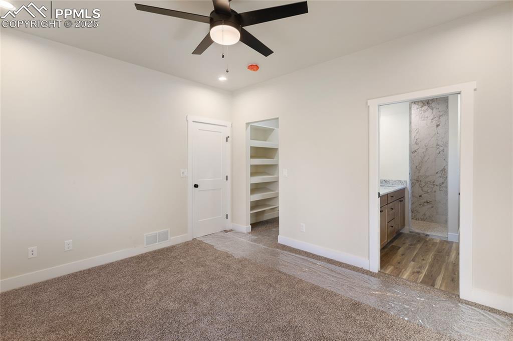 Image 20 of 38: Unfurnished bedroom with recessed lighting, carpet floors, ensuite bathroom