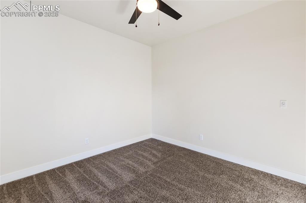 Image 27 of 38: Empty room featuring carpet and ceiling fan