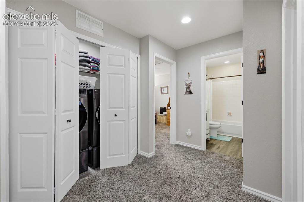 Image 14 of 41: Upper landing, featuring gray wall paint, gray carpeting, recessed ceiling
