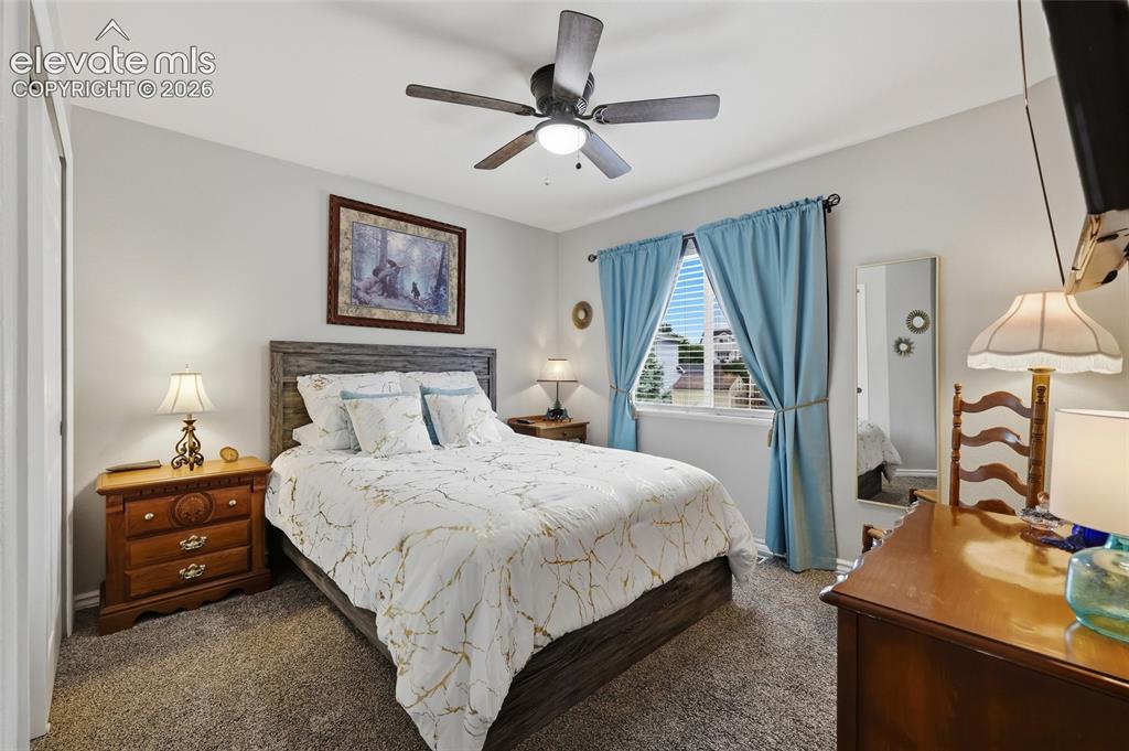 Image 17 of 41: Bedroom #2 (guest room). Textured carpet flooring, ceiling fan with integra