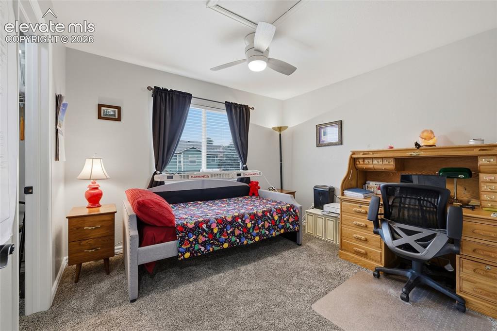 Image 18 of 41: Bedroom #3. Carpet, window with blinds, ceiling fan with integrated lightin