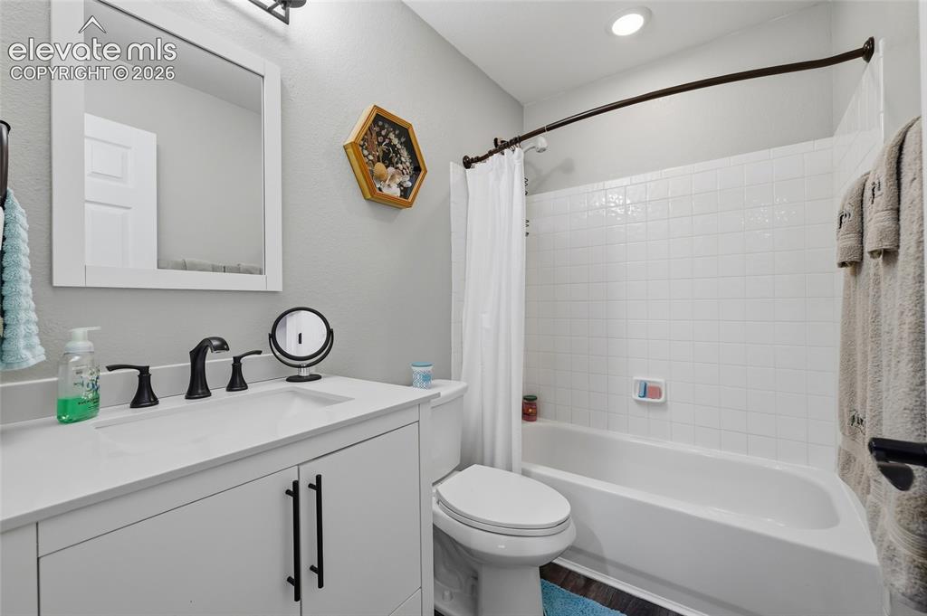 Image 19 of 41: Upstairs classic style hall bath, with white vanity, dual-handle matte blac