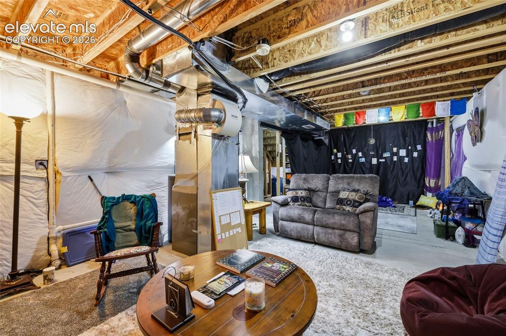 Image 21 of 41: Basement unfinished area being used as living area