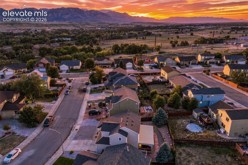 Image 35 of 41: Established residential neighborhood with a mountain backdrop, mature trees