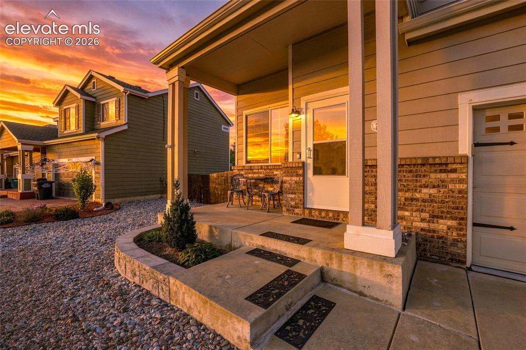 Image 4 of 41: Covered front porch with concrete steps