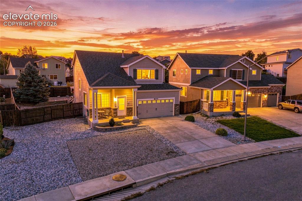 Image 41 of 41: Two-story residence featuring a covered front porch, attached two-car garag