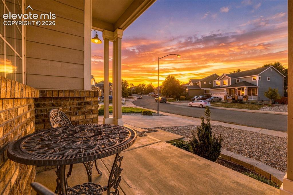Image 5 of 41: Covered front porch featuring a brick half-wall, siding exterior, and a bui