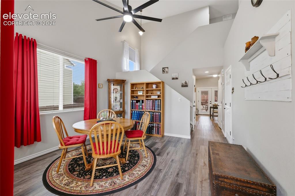 Image 6 of 41: Vaulted ceilings with a ceiling fan, wood-finish flooring, built-in shelvin