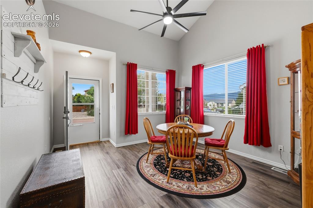 Image 7 of 41: Vaulted ceiling with a ceiling fan, multiple windows with blinds, and wood-