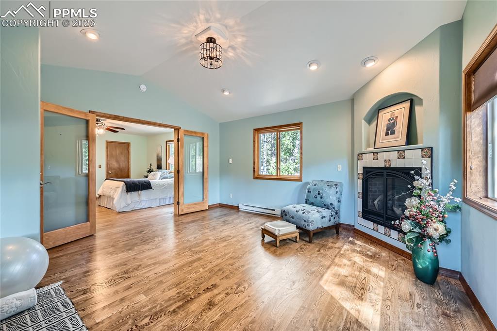 Image 17 of 37: Sitting room with French doors, fireplace, and walk-out to back deck from p