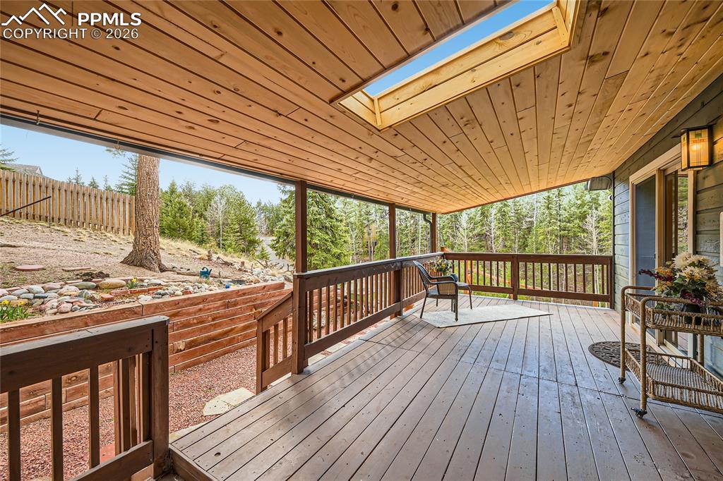 Image 9 of 37: Covered deck provides outdoor living space year round