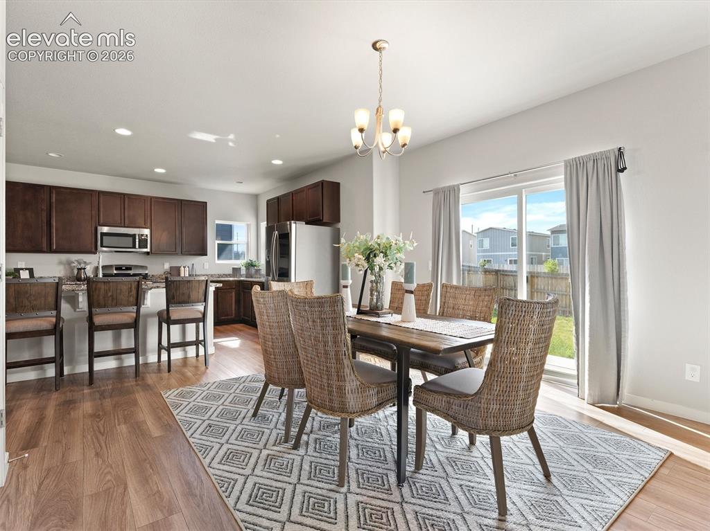 Image 12 of 46: Open-concept living space featuring wood-finish flooring, a kitchen island 