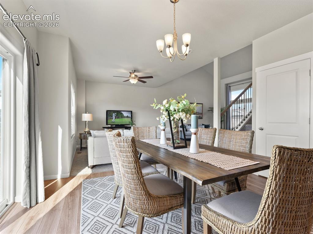 Image 13 of 46: Open-concept dining area featuring a wood-finish table with seating for six
