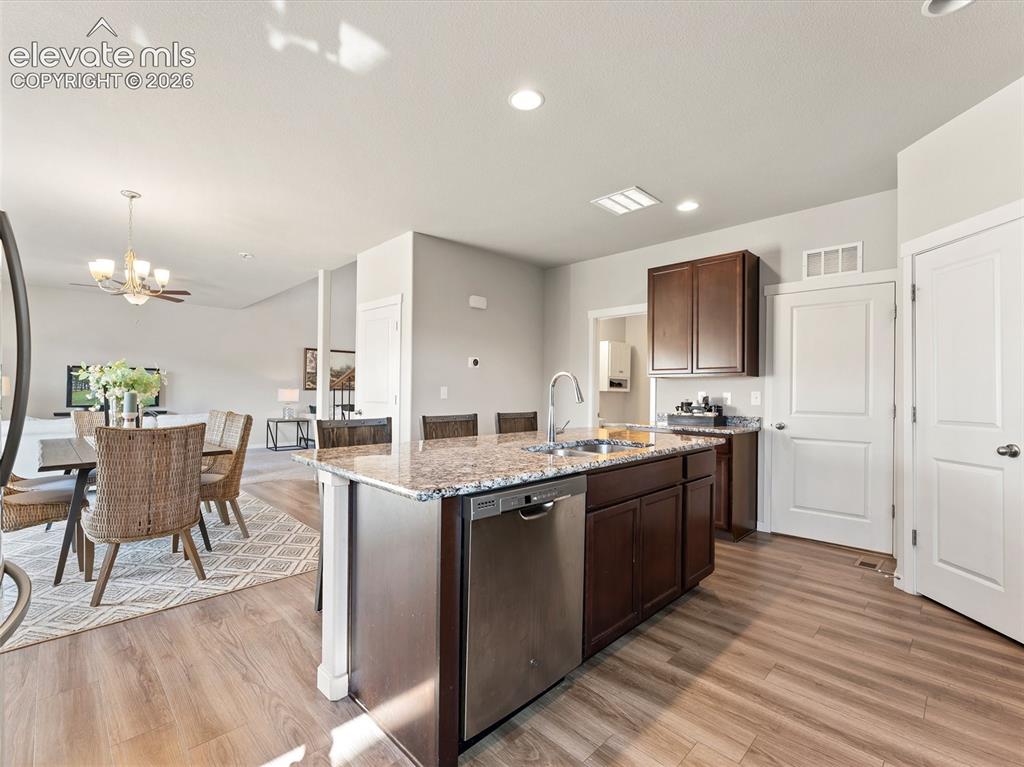 Image 16 of 46: Kitchen island featuring a double-basin stainless steel sink, gooseneck fau