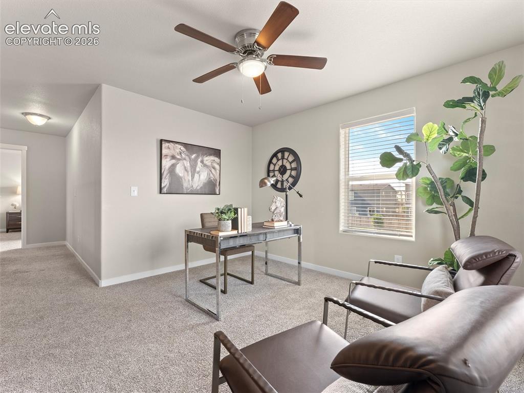 Image 23 of 46: Carpeted room featuring a ceiling fan with integrated lighting, a window wi