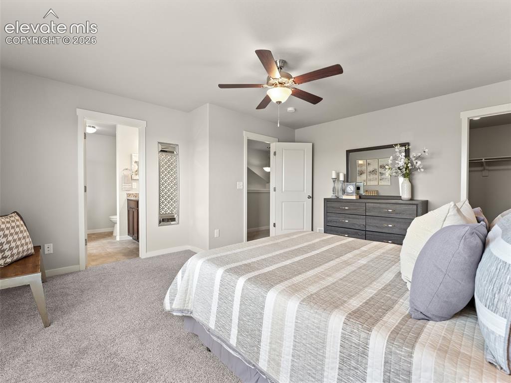 Image 26 of 46: Plush carpeting throughout this bedroom, featuring a ceiling fan with integ