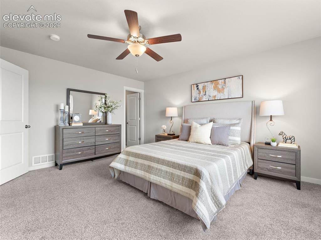 Image 27 of 46: Carpeted room featuring a ceiling fan with integrated lighting, a paneled d