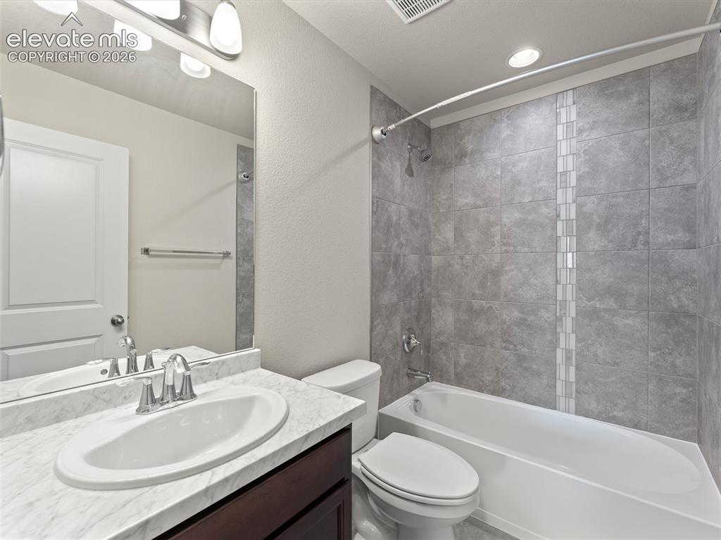 Image 34 of 46: Bathroom featuring a white oval undermount sink, a chrome faucet, and a sto