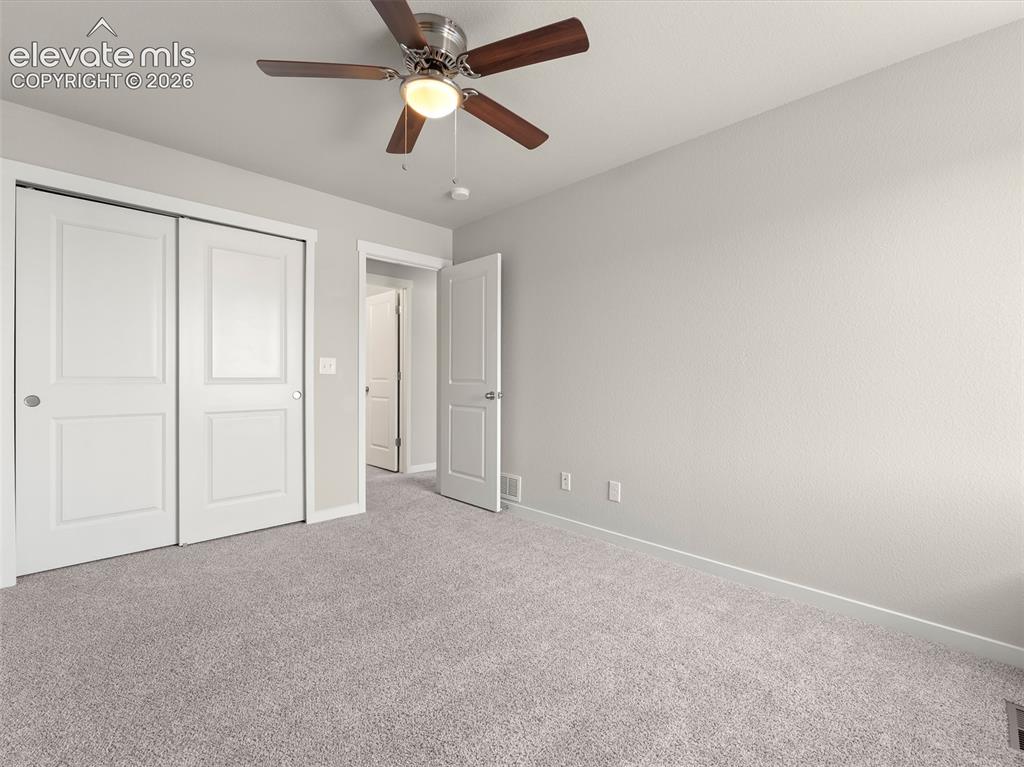 Image 36 of 46: Neutral-toned carpeting paired with light wall finishes