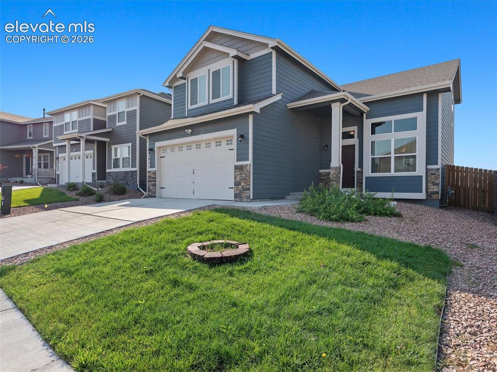 Image 4 of 46: Contemporary exterior featuring horizontal siding in a deep blue hue, accen