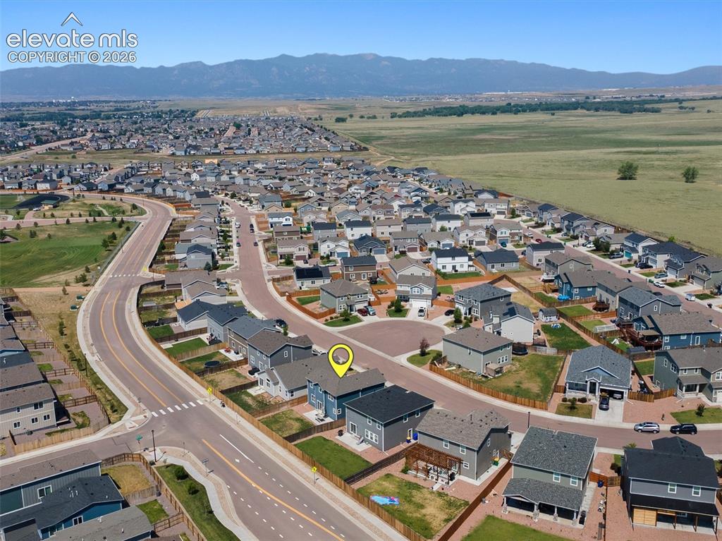 Image 43 of 46: Aerial perspective showcasing a residential neighborhood with mountain scen