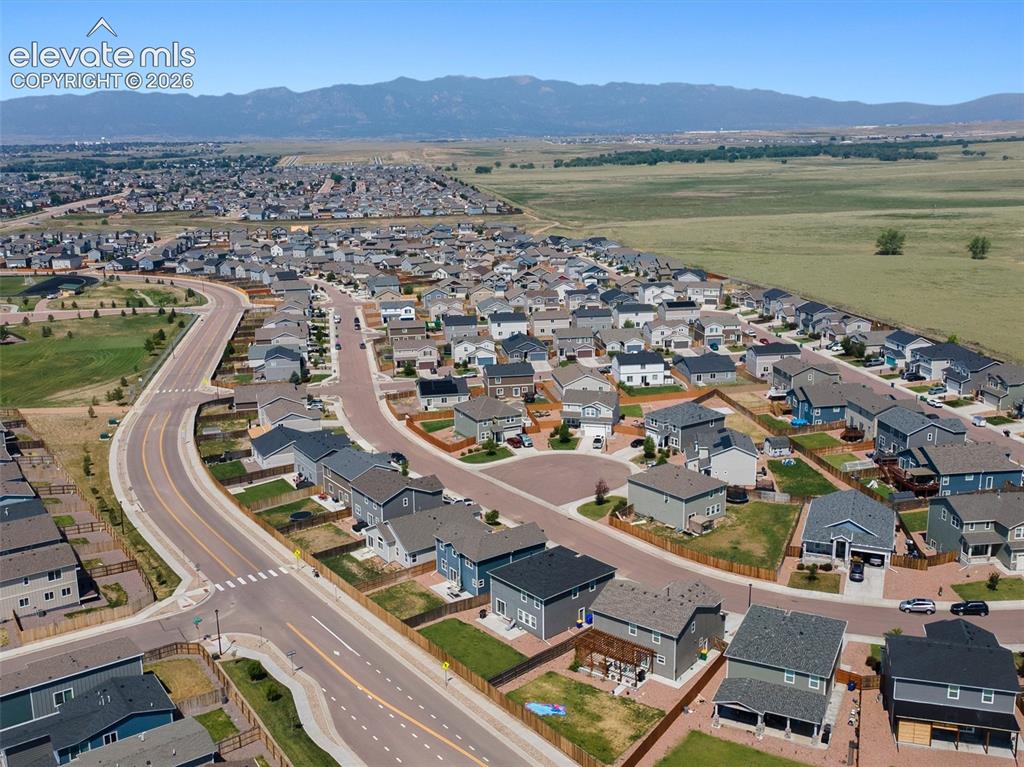 Image 44 of 46: Expansive aerial perspective showcasing a residential development with dist