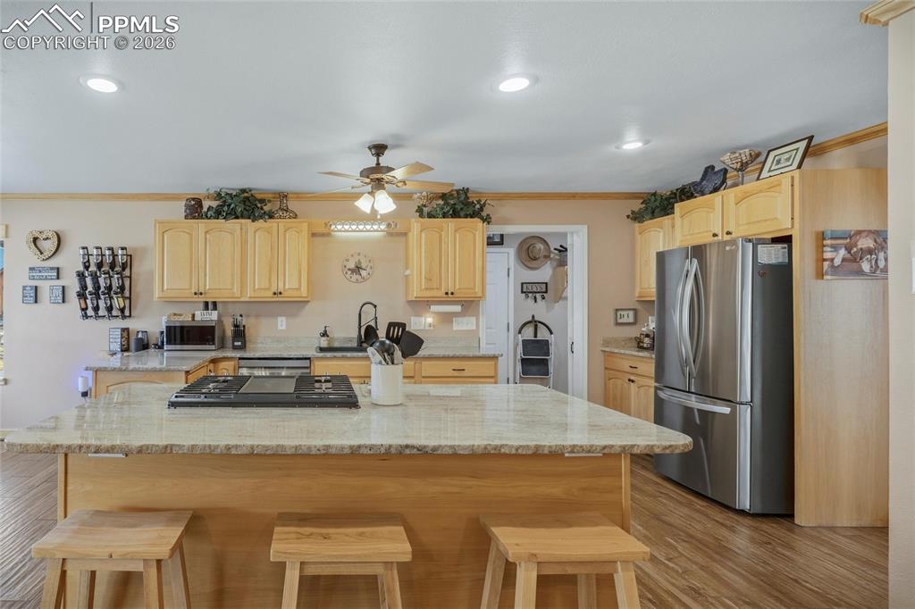 Image 15 of 50: Kitchen with light wood finish cabinets, stainless steel appliances, a kitc