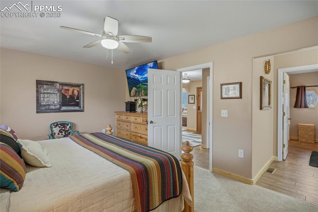 Image 19 of 50: Bedroom featuring light carpet and ceiling fan