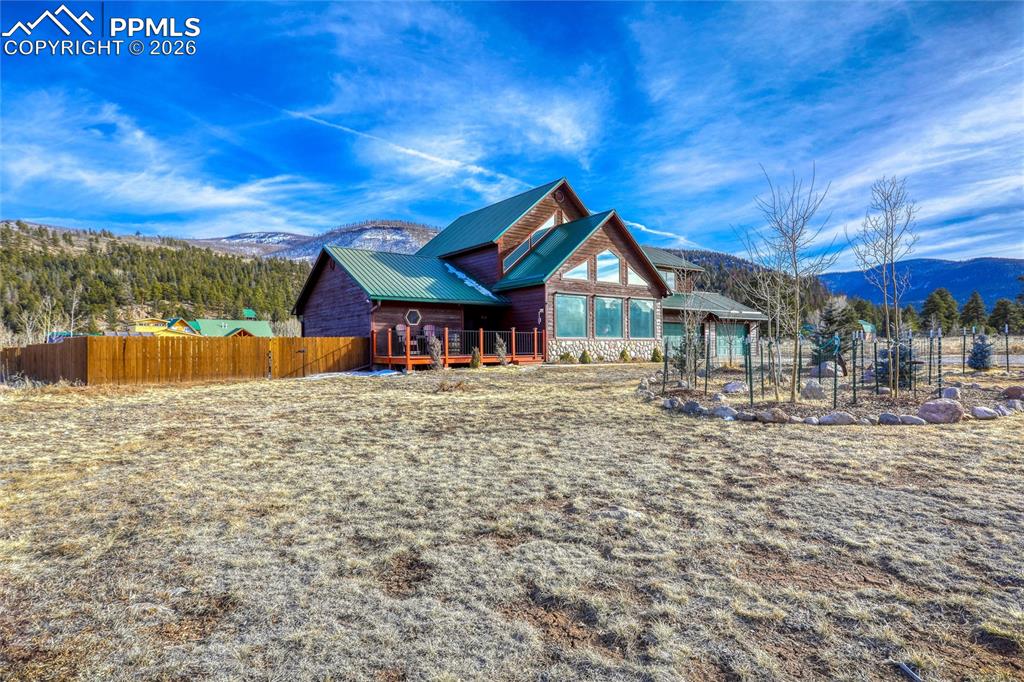 Image 3 of 50: Rear view of house with a mountain view and a metal roof