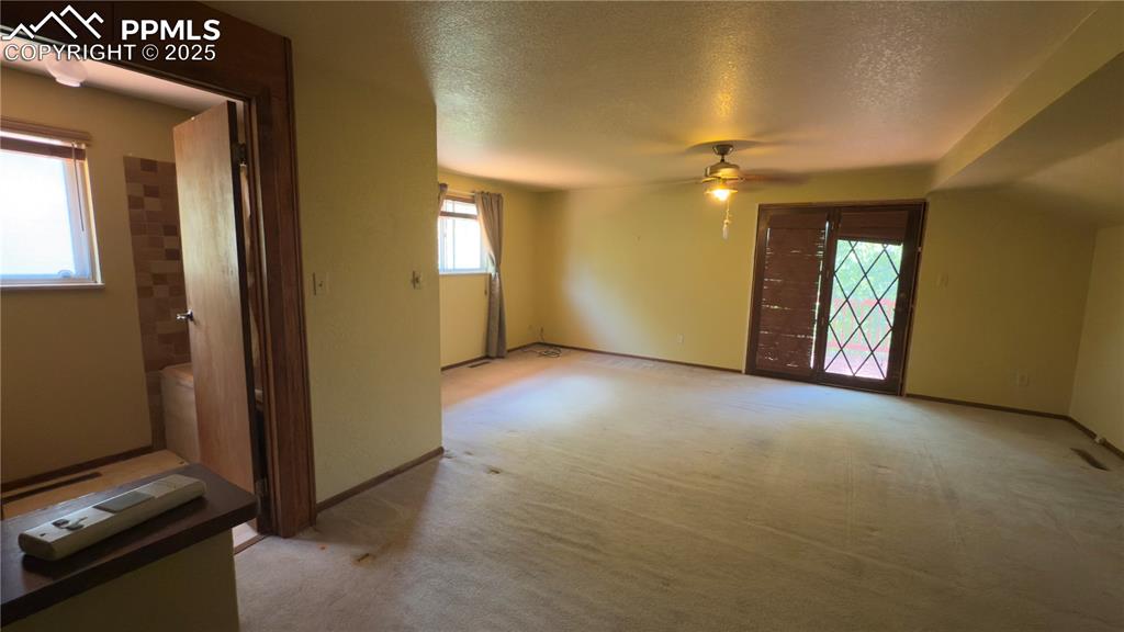 Image 15 of 17: Upper primary bedroom with bathroom attached, private deck