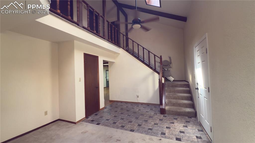 Image 2 of 17: Stairs featuring a high ceiling, ceiling fan, and carpet floors