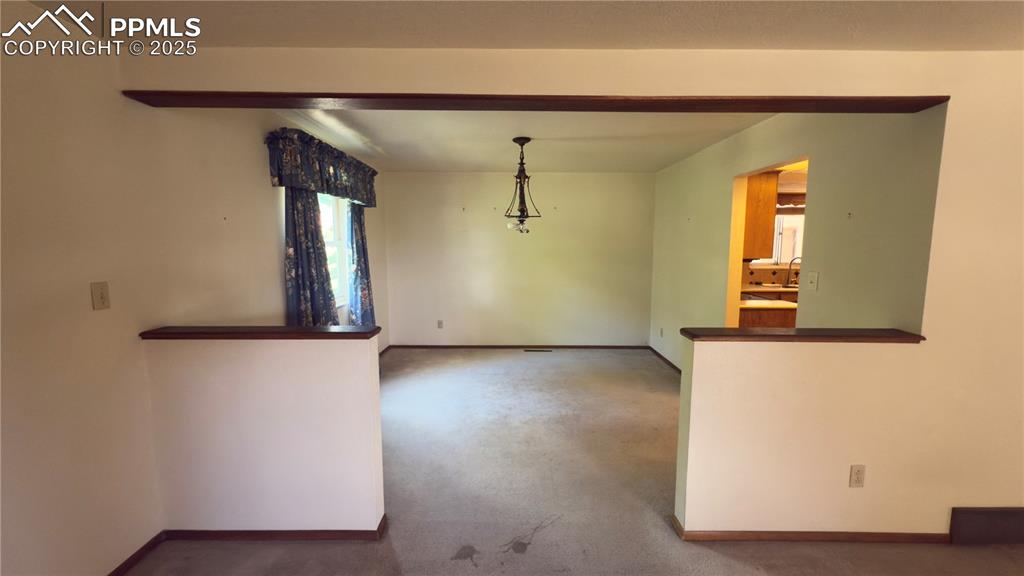 Image 3 of 17: Unfurnished dining area with baseboards and carpet