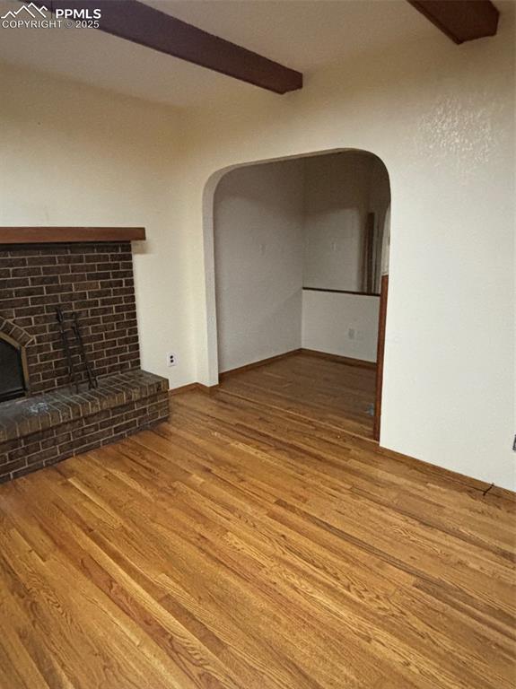 Image 8 of 17: Cubby area off family room featuring beam ceiling, wood finished floors, a