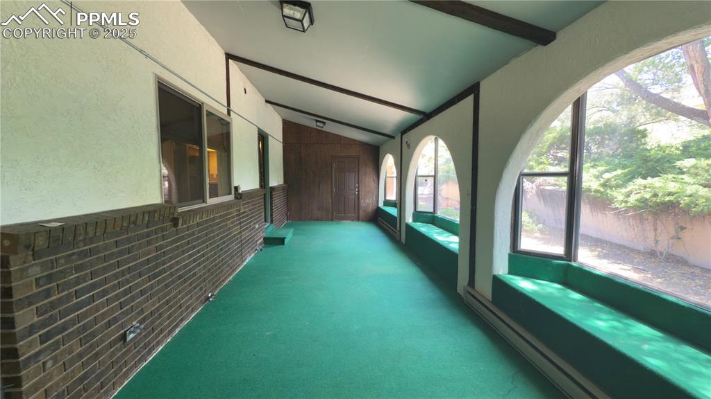 Image 9 of 17: Unfurnished sunroom with a baseboard heating unit