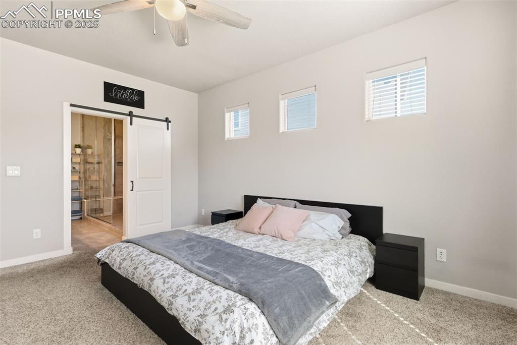 Image 14 of 34: Master bedroom on main level with ensuite bath