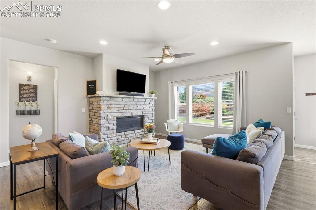 Image 4 of 34: Gas fireplace, high celings, and large windows