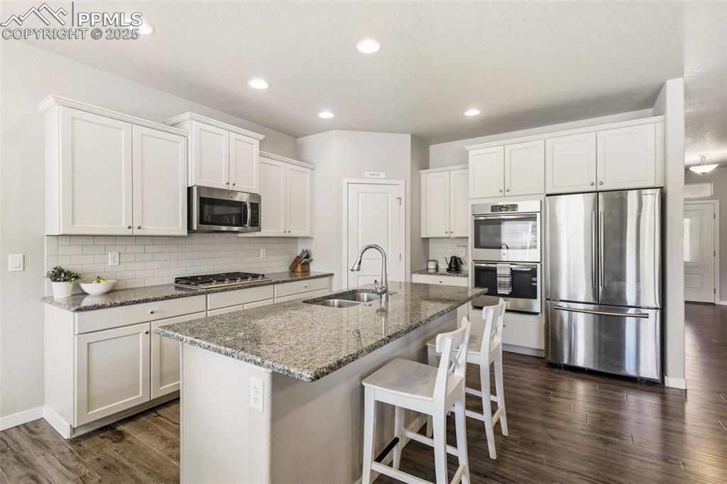 Image 7 of 34: Upgraded countetops, double ovens, stainless appliances, and a large island