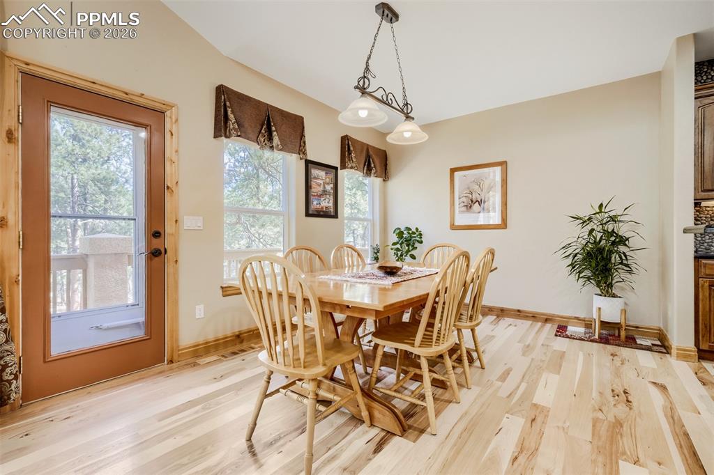 Image 11 of 49: Dining space with light hickory floors 
