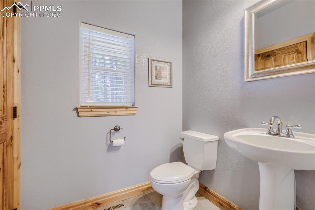 Image 13 of 49: Half bath on main level 