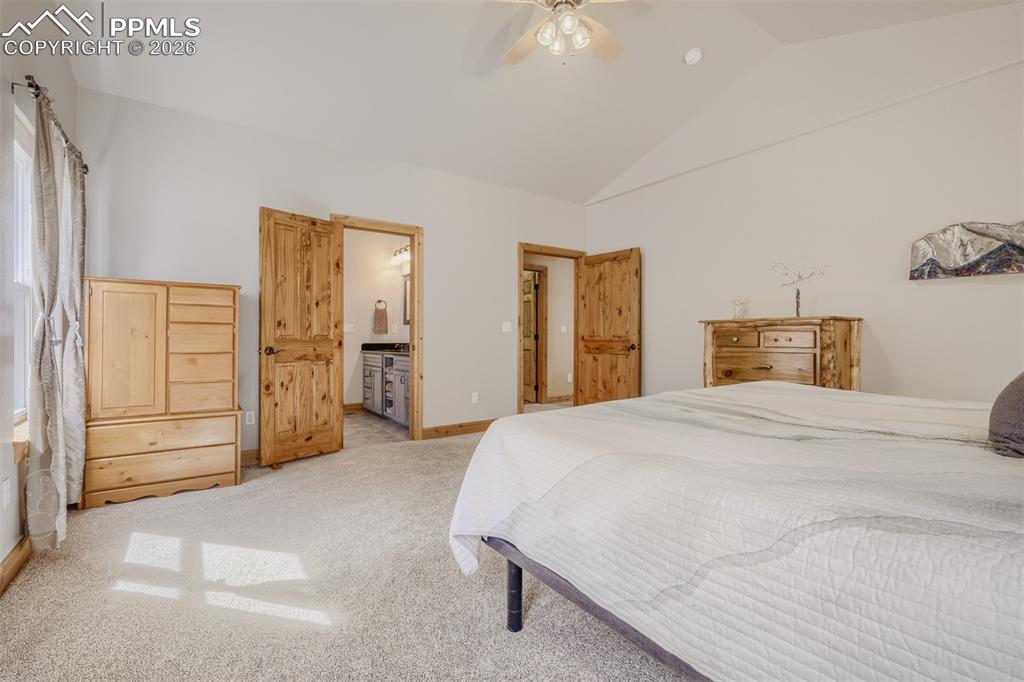 Image 16 of 49: Primary suite features vaulted ceilings, and adjoining 5-piece bath 