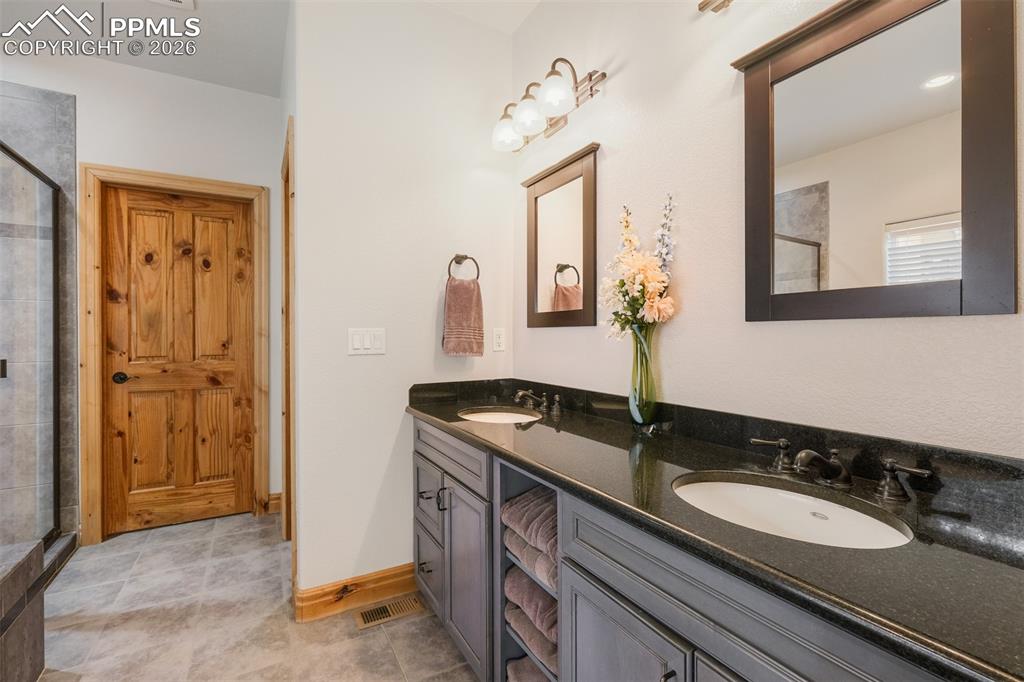 Image 17 of 49: Primary suite 5pc bathroom featuring double vanity and radiant floor heat 