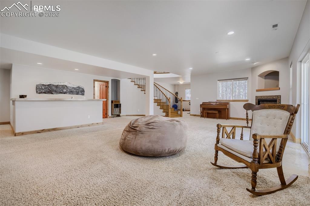 Image 22 of 49: Fully finished basement has 9’ ceilings, large family room w/gas fireplace,