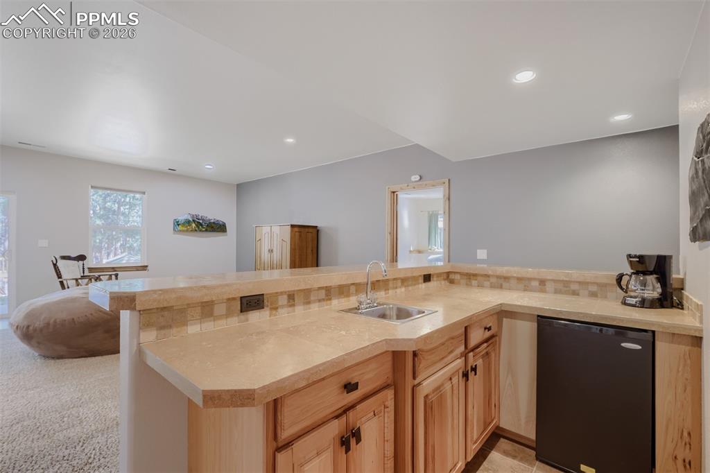 Image 23 of 49: Family room wet bar 