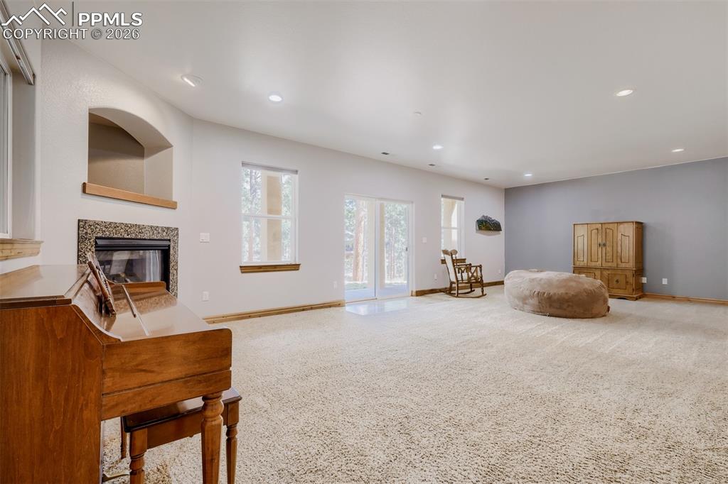 Image 24 of 49: Basement walkout leads to serene, tree filled yard