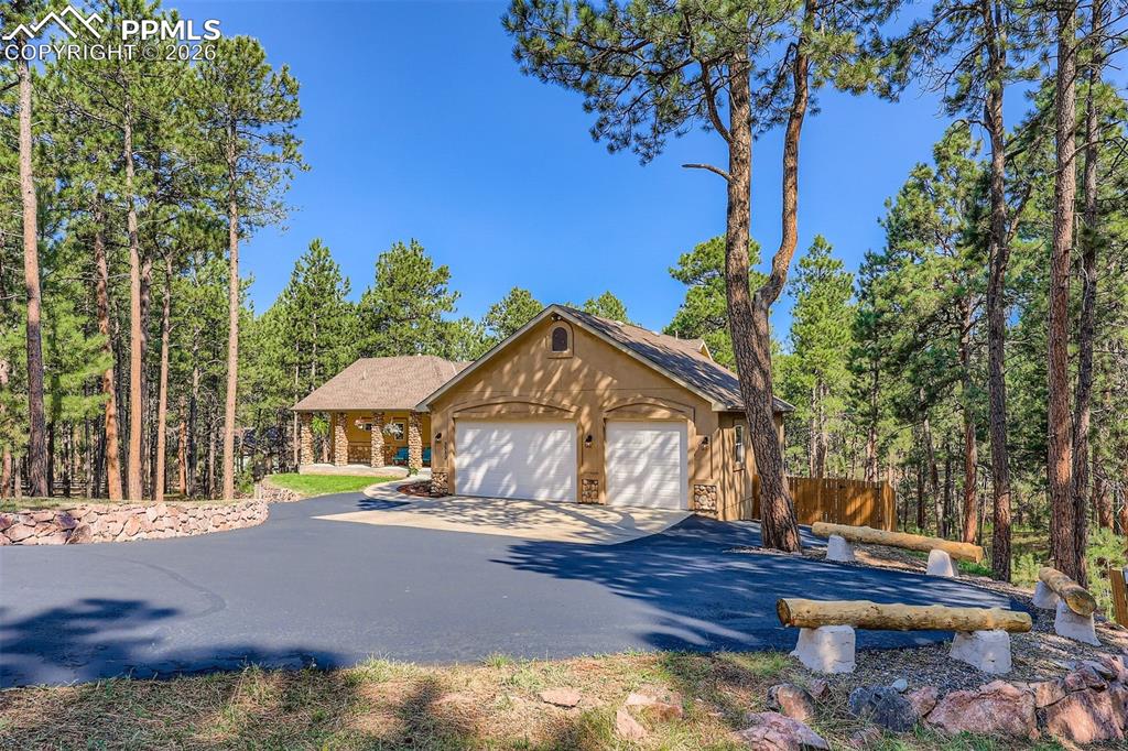 Image 3 of 49: Paved driveway provides RV parking, guest parking, and access to the oversi